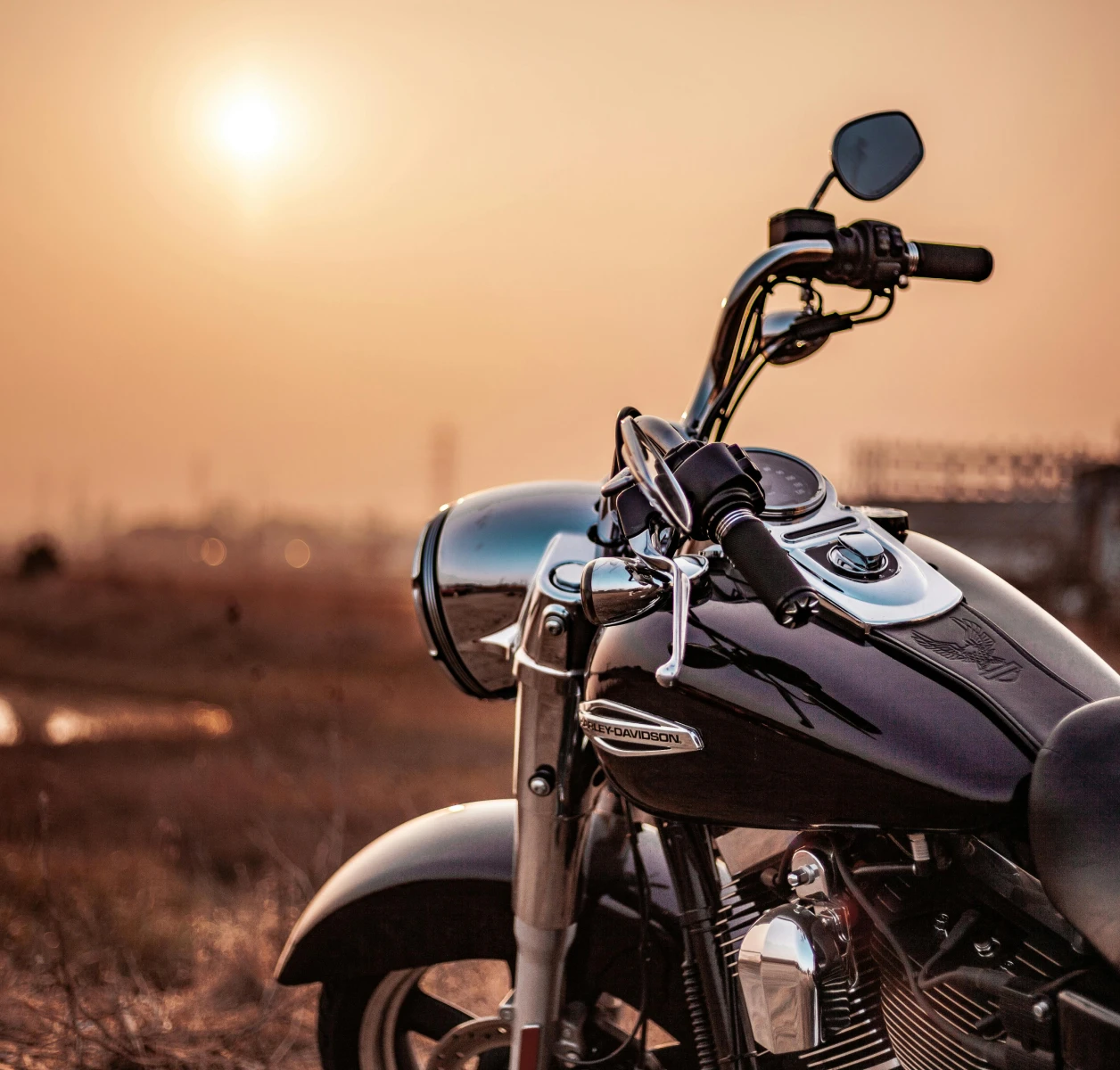 Motorcycle at sunset in open field